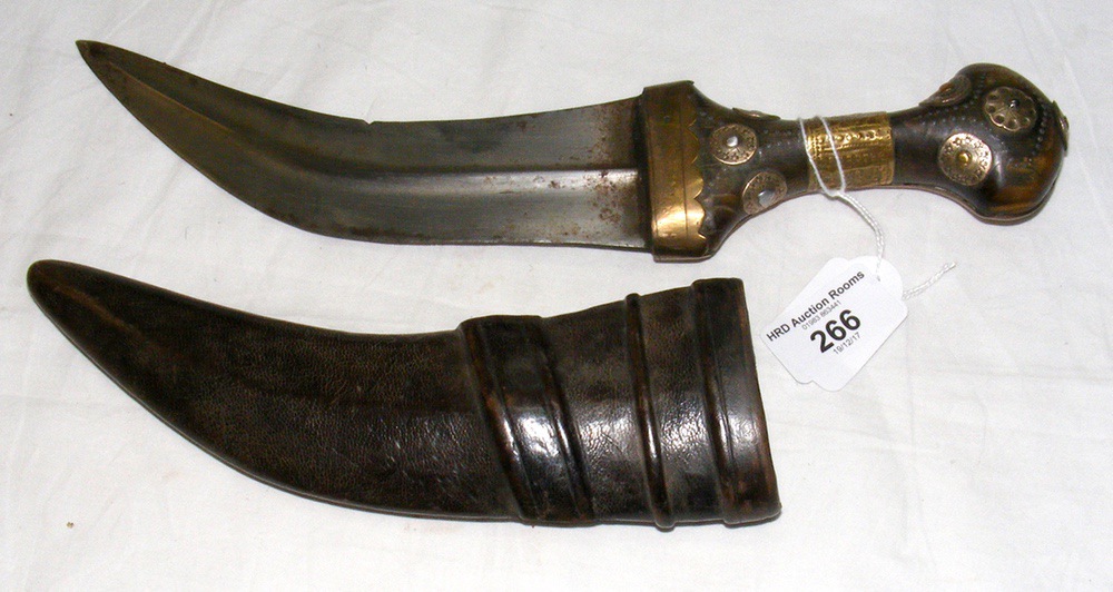 A decorative Jambiya with metal mounted handle and leather scabbard - 31cm long