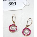 A pair of ruby and diamond earrings