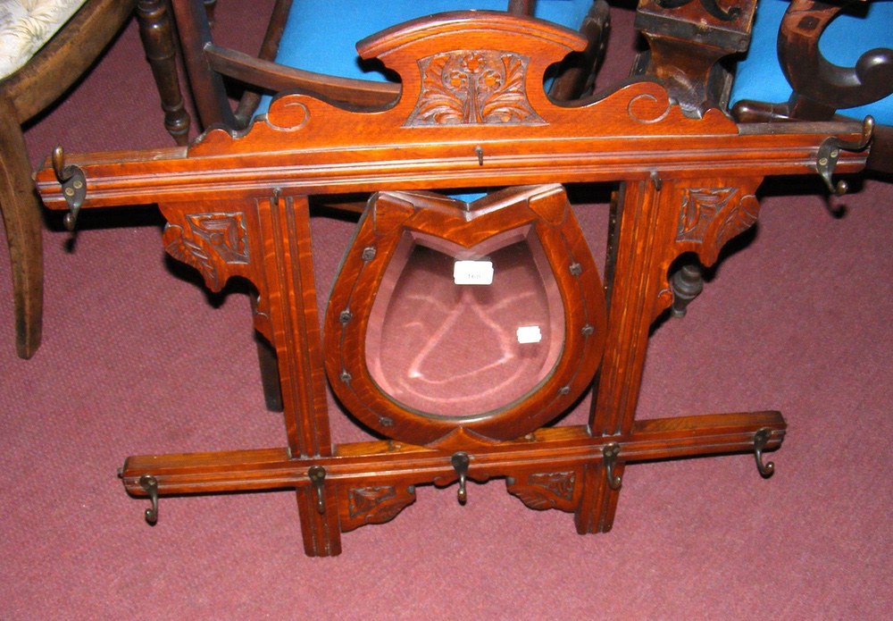 A carved wooden "Horseshoe" hanging coat rack