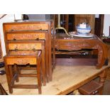 A nest of four carved oriental occasional tables and a carved oriental coffee table