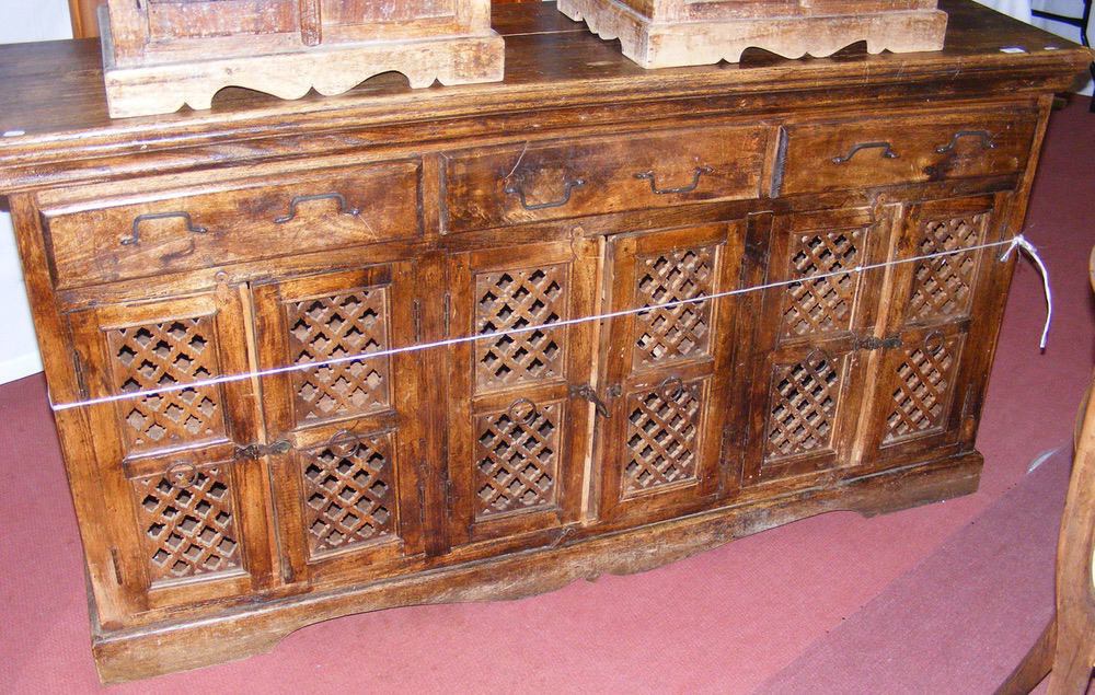 A rustic continental style sideboard with drawers and cupboards below