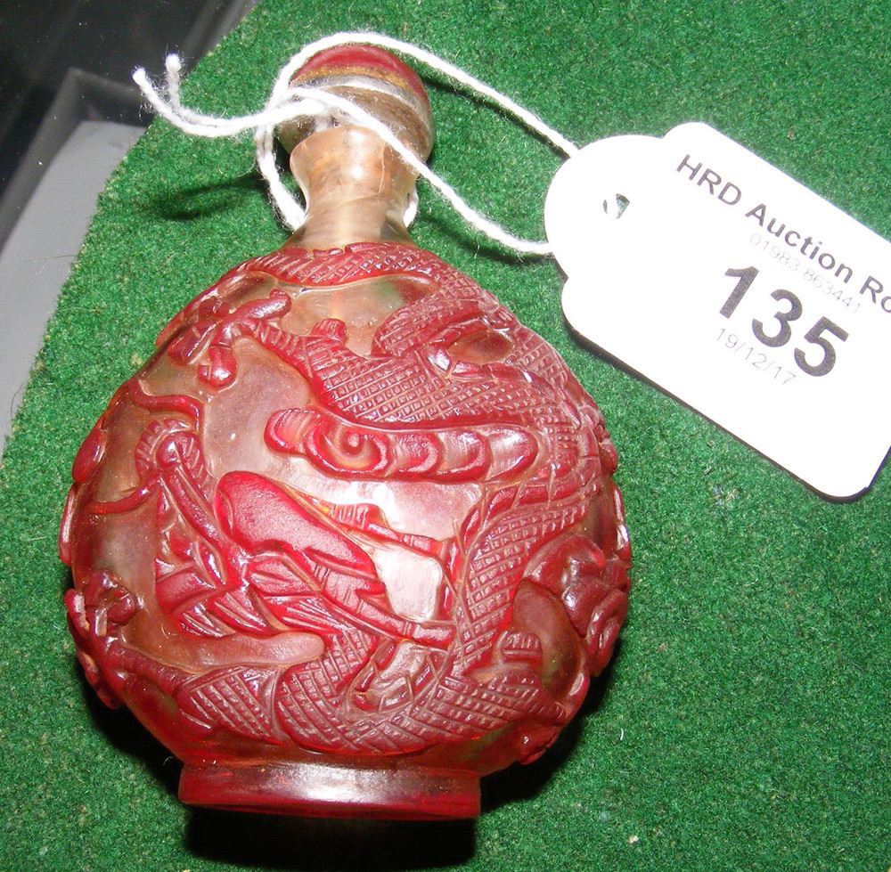 A red overlay (Peking glass) Chinese snuff bottle with glass top and ivory spoon - 7.5cm