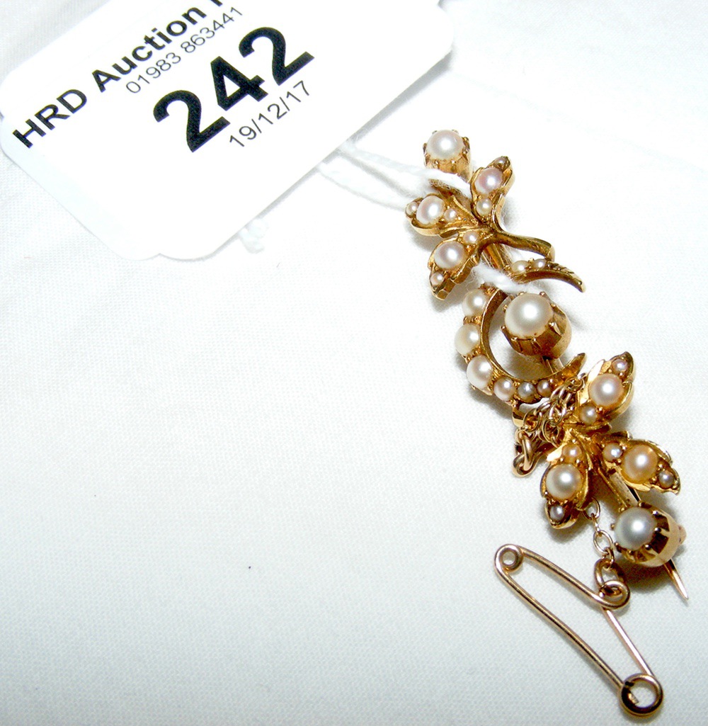 An Edwardian seed pearl crescent brooch in gold setting