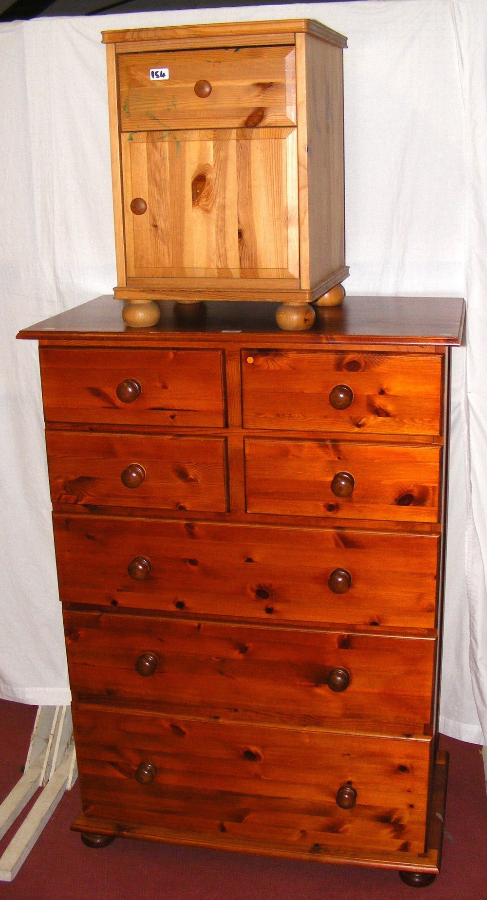 A pine chest of drawers, together with a pine bedside