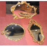 A decorative gilt wall mirror, together with two others