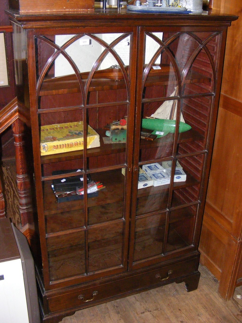 A two door display cabinet with drawer to base
