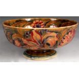 An early William Moorcroft shallow pedestal BOWL tube lined and painted with continuous bands of