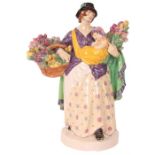 CHARLES VYSE - 1922 A finely modelled earthenware FIGURE depicting a flower seller colourfully