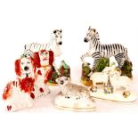 A matched pair of 19th Century Staffordshire ZEBRAS on stumpwork grassy bases 12.5cm high, two small
