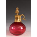 A late 19th Century deep Cranberry and Gilt Metal mounted bulbous DECANTER with vine leaf ring