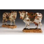 An unusual pair of 18th Century Delft MODELS of MILK COWS each with painted polychrome saddles and