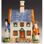 An early 19th Century Pratt type Polychrome MONEY BOX in the form of a HOUSE modelled with a