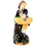 A 19th Century Minton Polychrome FIGURAL SWEETMEAT BASKET of a boy standing on a stumpwork base -