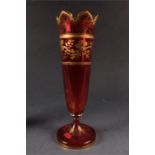 A 19th Century Bohemian Ruby Glass flared pedestal VASE with cut petal-shaped rim decorated all over