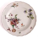 A mid 18th Century Chelsea CABINET PLATE with scalloped border enclosing a painted flower spray