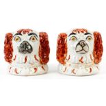 AN UNUSUAL PAIR OF MID 19th CENTURY STAFFORDSHIRE WINDOW STOPS modelled as Spaniels Dog Heads having