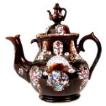 A LATE 19TH CENTURY MEASHAM WARE GIANT TEAPOT AND COVER WITH MINIATURE TEAPOT FINIAL Treacle