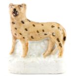 AN UNUSUAL LATE 19TH CENTURY SMALL STAFFORDSHIRE FIGURE OF A LEOPARD 8.5cm high