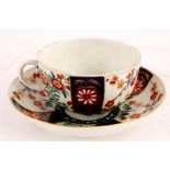 A FIRST PERIOD WORCESTER POLYCHROME TEA CUP AND SAUCER with colourful flower spray decoration in the