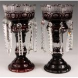 A PAIR OF LATE BOHEMIAN DEEP RUBY AND CUT GLASS LUSTRES with circular bases, knopped stems and