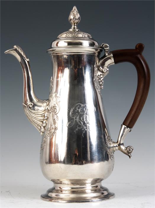 A GEORGE II SILVER COFFEE POT of footed slender slightly baluster form, the pear wood handle with