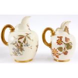 TWO GRADUATED LARGE ROYAL WORCESTER IVORY GROUND GILT EDGED FLATBACK JUGS with gilded celery type