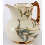 A ROYAL WORCESTER IVORY GROUND SQUAT BULBOUS JUG with moulded pouring spout and gilt leaf work