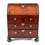 AN EARLY 18TH CENTURY QUEEN ANNE SOLID WALNUT SMALL BUREAU with hinged fall front revealing a