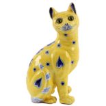 A 'GALLE' STYLE FAIENCE LARGE POTTERY MODEL OF A SEATED CAT painted in lemon yellow with blue