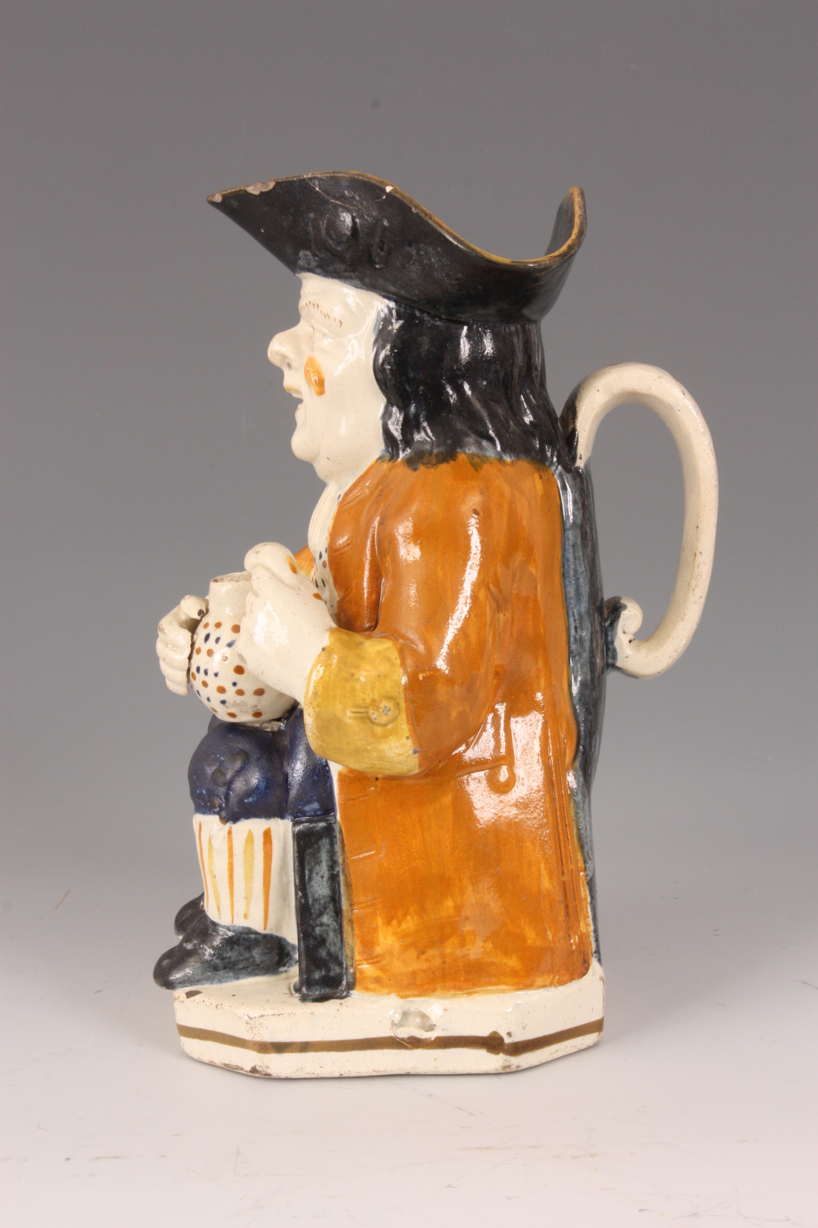 A GEORGE III STAFFORDSHIRE TOBY JUG the seated man holding a jug of ale in ochre hat with mustard - Image 7 of 10