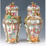 A PAIR OF 19th CENTURY CHINESE CANTON LIDDED VASES with entwined gilt dragons, floral scenes with