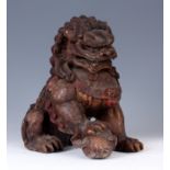 A 19TH CENTURY ORIENTAL PAINTED CARVED WOOD DOG OF FOO 29cm high 30cm across.