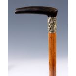 A LATE 19TH CENTURY RHINO HORN HANDLED WALKING STICK with Malacca cane 83cm overall.