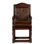 A LATE 17TH CENTURY AND LATER PANELLED BACK WAINSCOTT CHAIR with shaped top rail above a carved