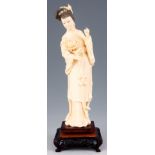 A LATE 19TH CENTURY CHINESE CARVED IVORY FIGURE the young lady in Oriental dress holding a rose