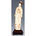 A LATE 19TH CENTURY CHINESE CARVED IVORY FIGURE the young lady in Oriental dress holding a rose