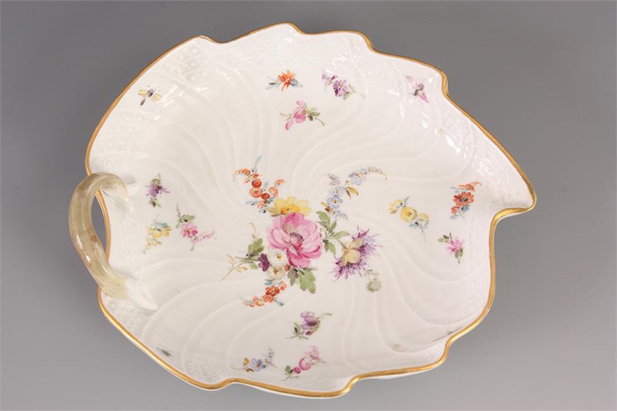 AN EARLY 19th CENTURY LEAF SHAPED MEISSEN DISH with floral spray decoration 19cm across.