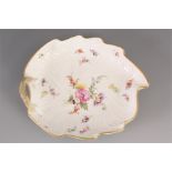 AN EARLY 19th CENTURY LEAF SHAPED MEISSEN DISH with floral spray decoration 19cm across.