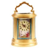A 19th CENTURY MINIATURE FRENCH BRASS OVAL CASED PORCELAIN PANELLED CARRIAGE CLOCK, the panels