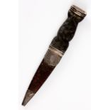 A SILVER MOUNTED SKEAN DHU the dark wood studded hilt with strap work outer face and amber