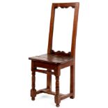 AN EARLY 18TH CENTURY OAK CHILDS SIDE CHAIR with open pegged back, plank seat and turned legs joined