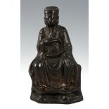 A SMALL CHINESE  MING PERIOD BRONZE of a seated emperor having traces of original gilding 15.5cm