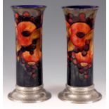 A LARGE PAIR OF WILLIAM MOORCROFT POMEGRANATE CYLINDRICAL VASES WITH PEWTER BASES tube lined and