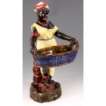 A LARGE 19TH CENTURY FRENCH MAJOLICA BLACKAMORE FIGURE of a woman in yellow dress and decorative red