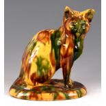 A 19th CENTURY STAFFORDSHIRE SLIPWARE SEATED CAT on a yellow ground with green and brown colours