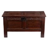 A LATE 17TH CENTURY JOINED OAK COFFER with a hinged two panel top above a carved top rail and