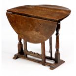 AN 18TH CENTURY SMALL OAK SLEDGE BASE GATE LEG TABLE the oval drop leaf top standing on ring