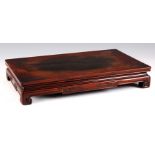 A 19th CENTURY CHINESE HARDWOOD STAND with decorative plinth, paper stamp to underside 37cm wide,