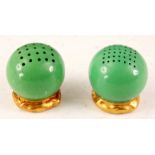 A ROYAL WORCESTER CIRCULAR GREEN SALT AND PEPPER CONDIMENT SET having pierced tops and gilt