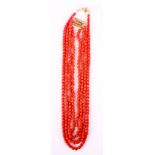 A SET OF FOUR CORAL BEAD NECKLACES with gold metal clasps, three measuring 44cm one measuring 50cm.